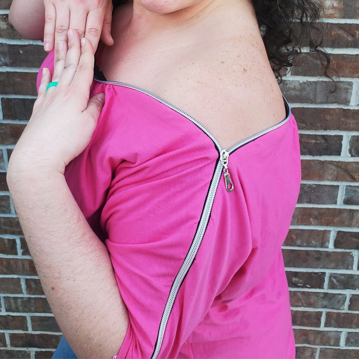 Close-up of the exposed shoulder zipper on the pink boatneck zipper shirt