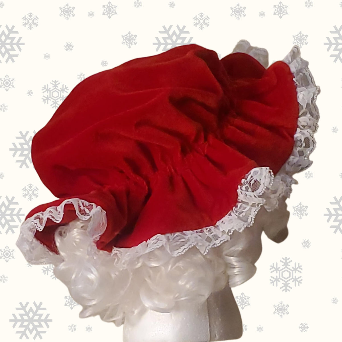 Back view of the gathered red velvet Mrs Claus hat with lace edge