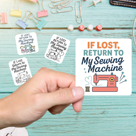 Hand holding an If Lost Return to My Sewing Machine sticker with a coral sewing machine, more stickers on a teal desk