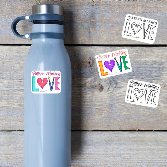 Pattern Making Love stickers on a blue water bottle and wood table, LOVE spelled with a ruler, heart and tracing wheels