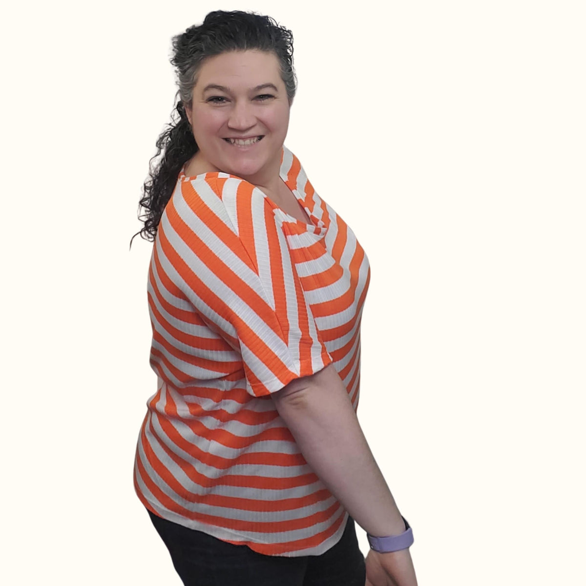 Side view of the orange and white striped cozy knit dolman shirt