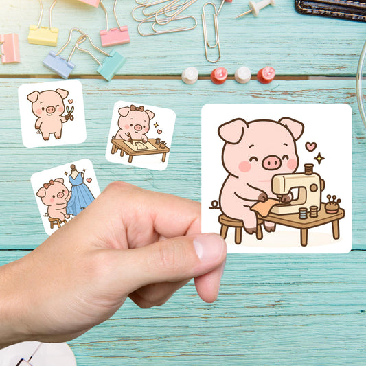 Hand holding a pig sewing sticker of a pig at a sewing machine, with more pig stickers on a teal desk
