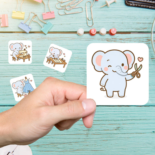 Hand holding an elephant sewing sticker of an elephant with scissors, with more elephant stickers on a teal desk