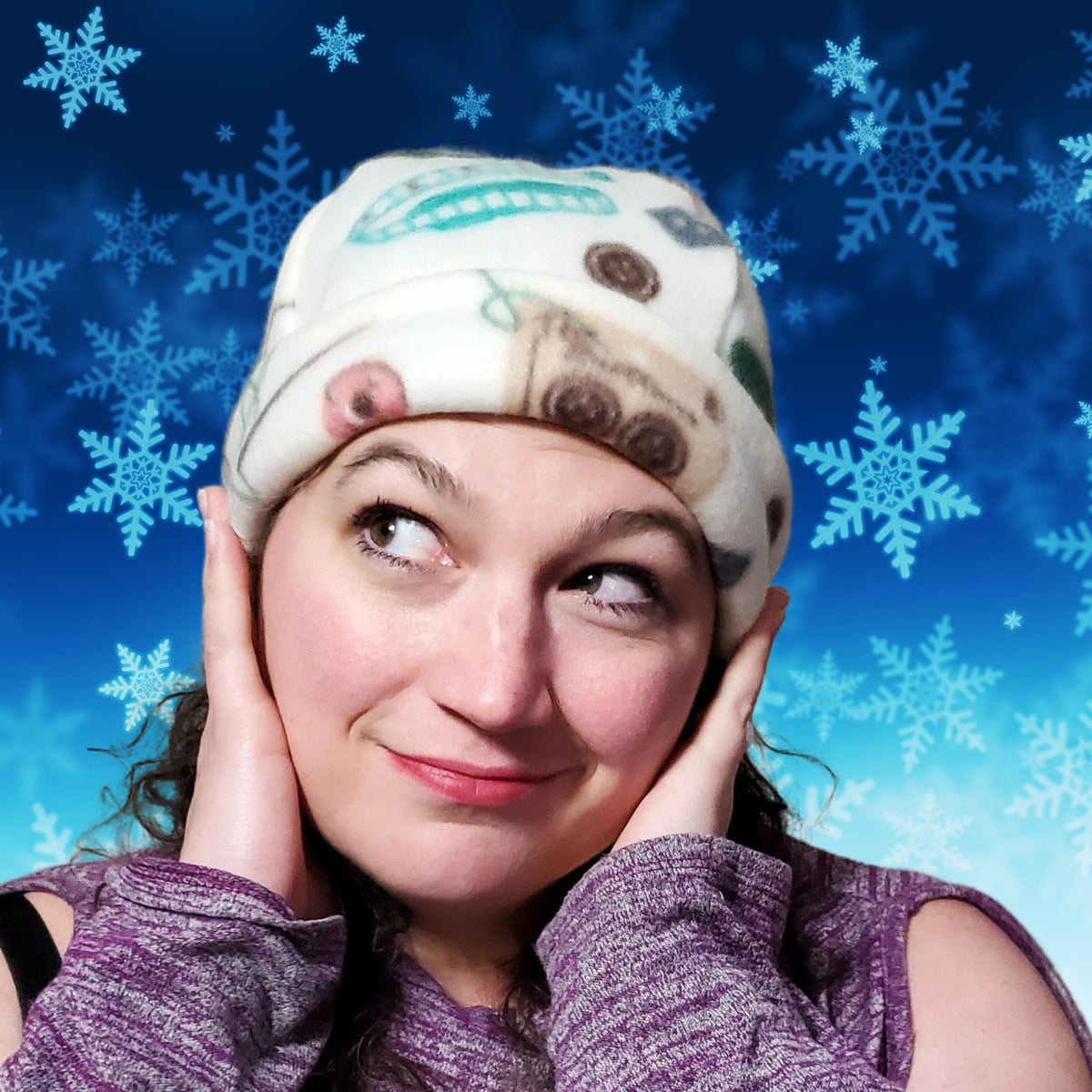 Woman wearing a cozy printed fleece winter cap on a blue snowflake background