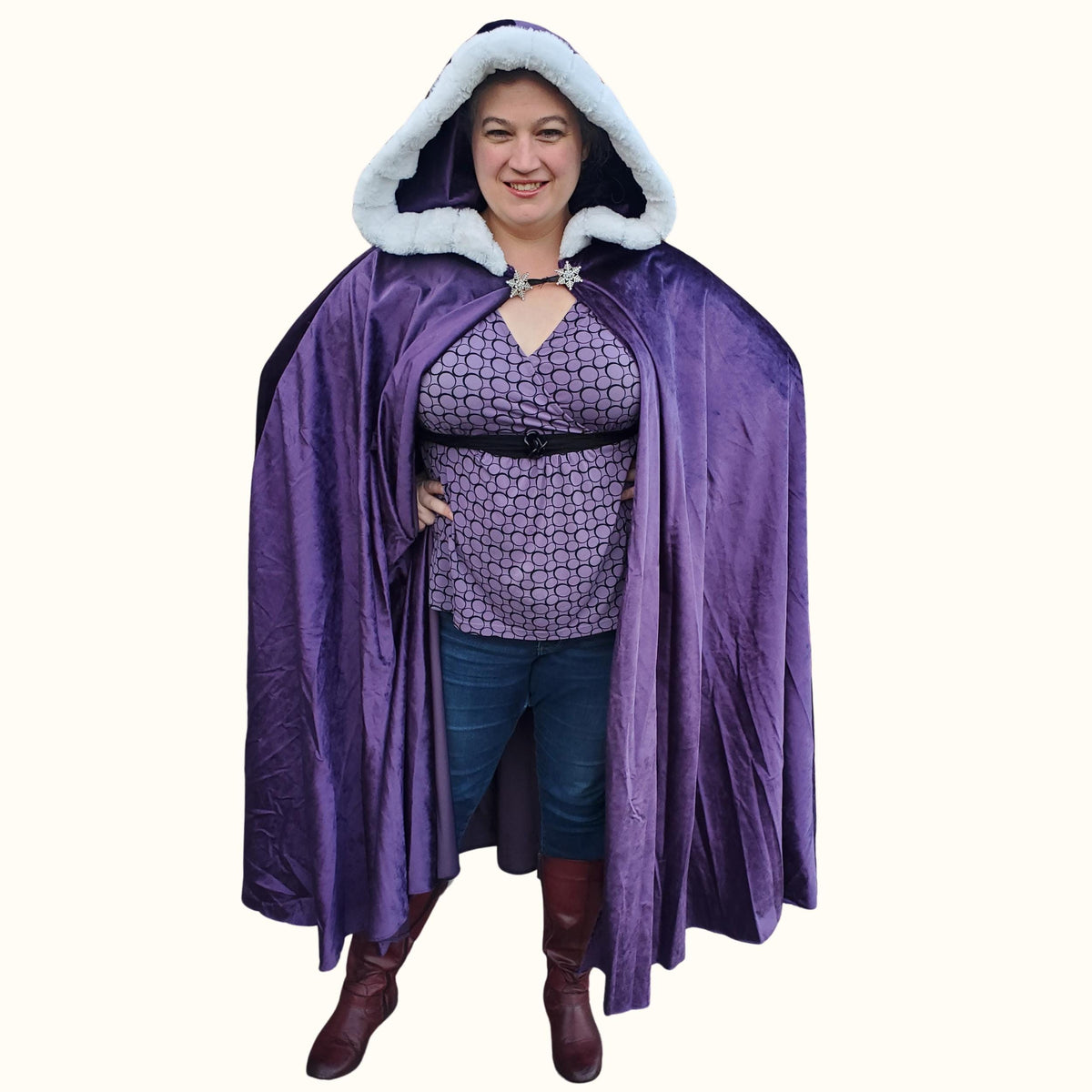 Woman in a purple velvet circle cape with a white faux fur hood