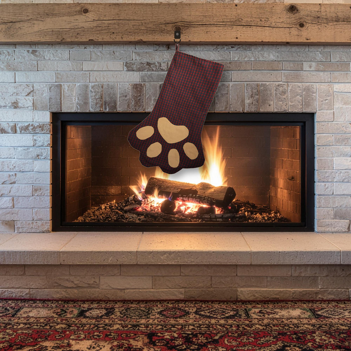 Burgundy plaid paw stocking with tan paw pads hanging on a fireplace mantel