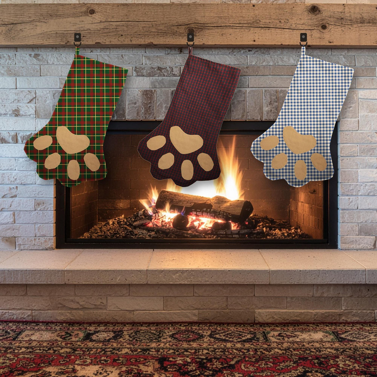 Three paw stockings in green plaid, burgundy and gingham fabrics with tan paw pads hanging over a fireplace