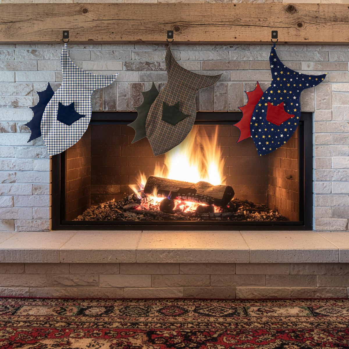 Three fish stockings in gingham, brown plaid and navy star fabrics with contrast fins hanging on a fireplace mantel
