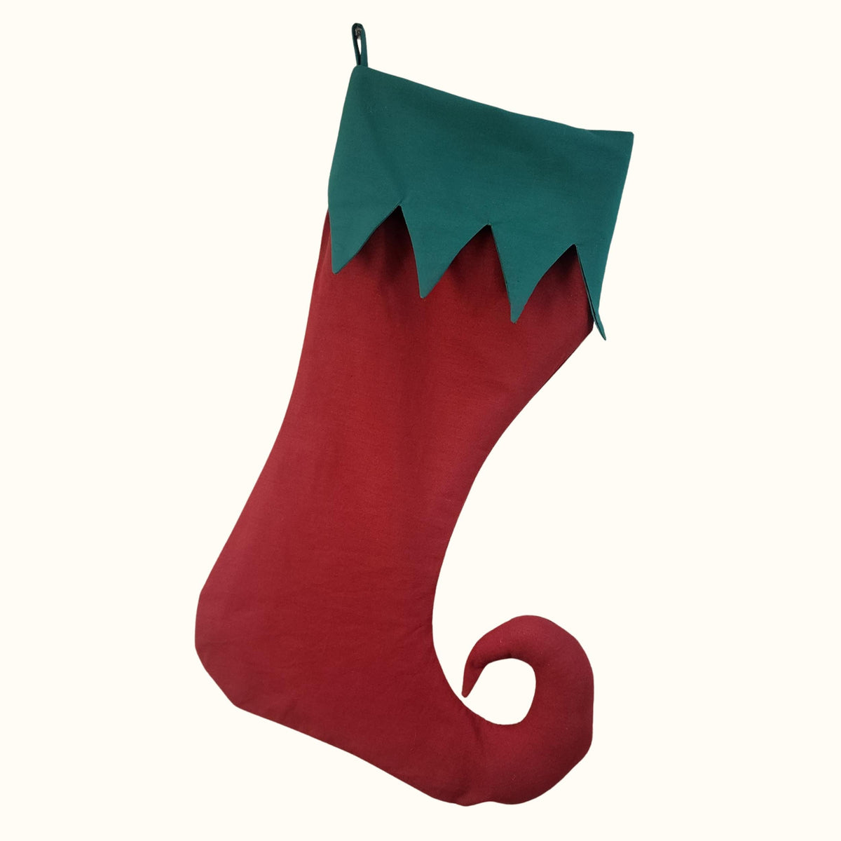 Finished red elf stocking with a green zigzag cuff and curled toe